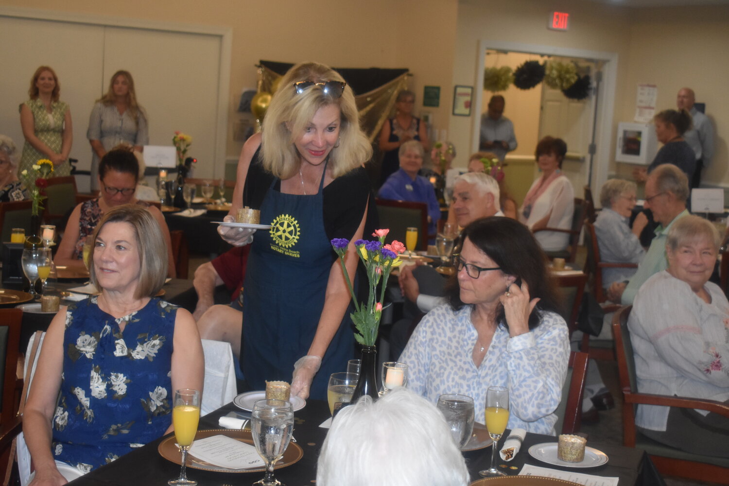 Members of the Rotary Club of Ponte Vedra Beach were on hand to serve food and present roses during the event.